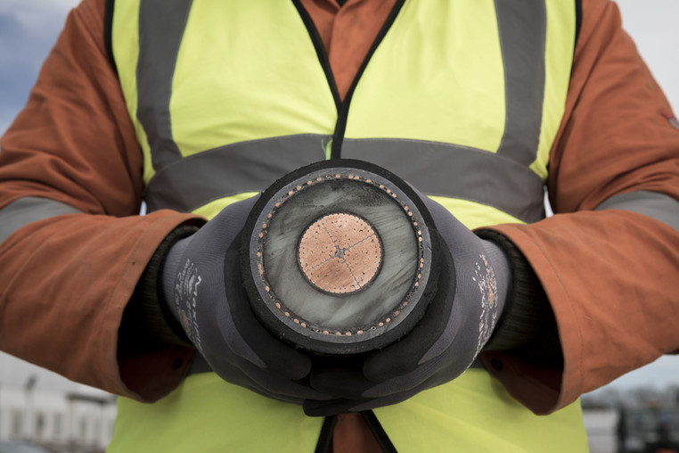 Person holding a section of an interconnector cable